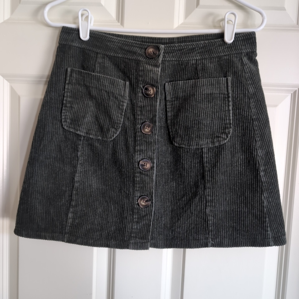 Olive green corduroy mini skirt with 70s style sailor pockets and tortoiseshell